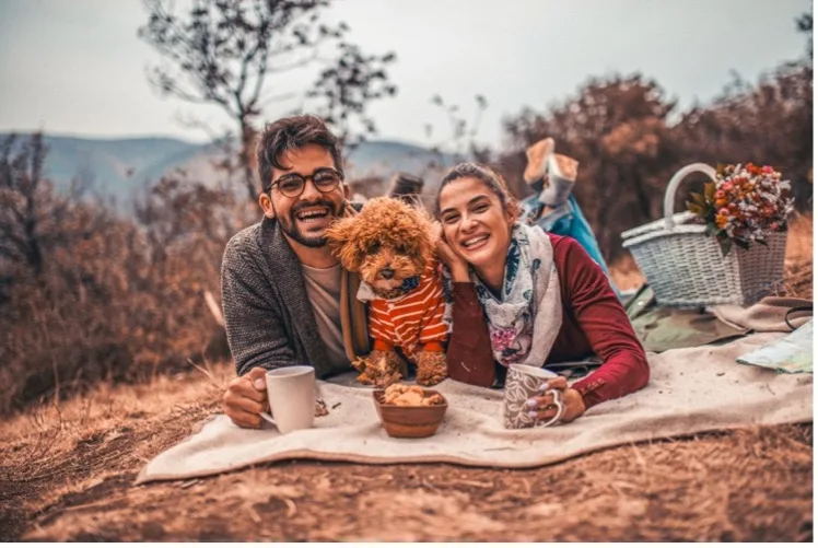 Family with small brown dog